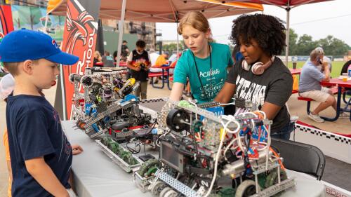 Students playing with robots at Fluor Field.