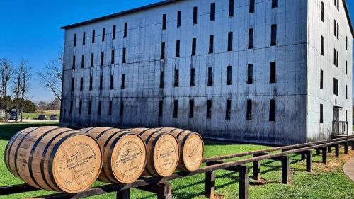 Bourbon barrels in front of a rick house.