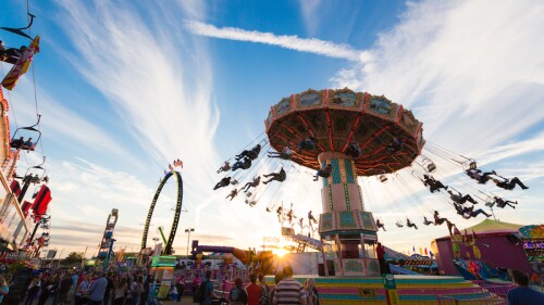 People swinging on a carnival ride.