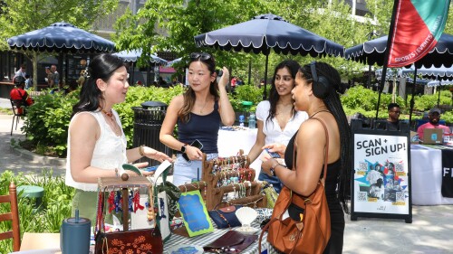 A group of girls shopping at an outdoor market in Water Park.