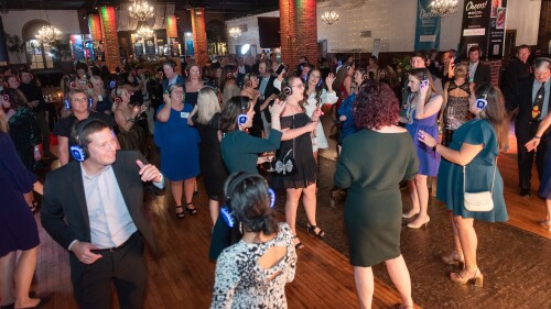 a large group of people dance in a silent disco