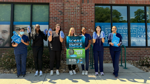 seven carolinasdentist empoloyees pose to promote an invisalign event