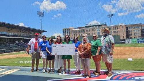 SC Lt. Governor Pamela Evette and AFL team members posing for a check at Fluor Field.