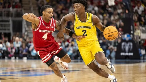 L.J. Cason (#2) fights off another player for the ball during a basketball game.