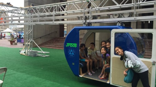 An image of kids sitting in a JPod.