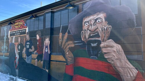Black House Cafe exterior mural with Freddy Kreuger and scared children.