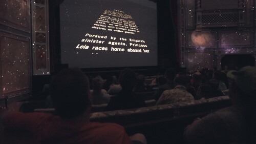 An audience in Carolina Theatre watches the opening scene of "Star Wars" on the big screen.