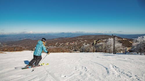 A women skiing down a mountain. 
