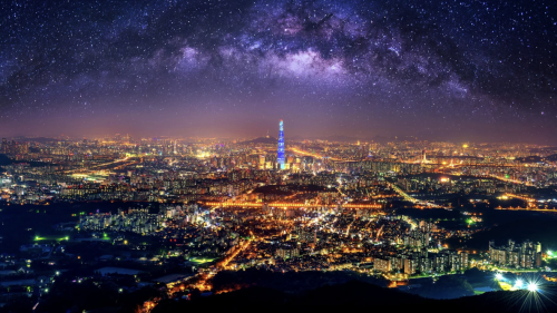 A vibrant cityscape at night with a brightly lit tower at the center, under a starry sky with the Milky Way visible, creating a majestic and serene atmosphere.