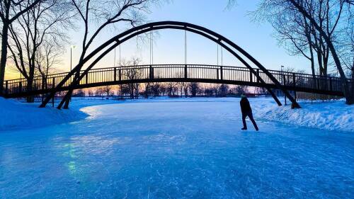 ice skater going under a bridge