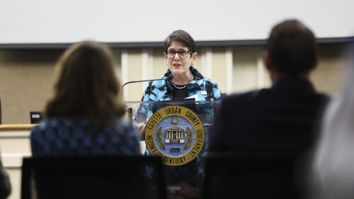 Mayor Linda Gorton standing in front of a podium speaking