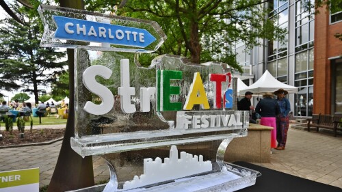 An ice sculpture with the words Charlotte StrEATS Festival carved into it.
