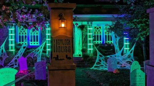 A house decorated with grave stones, lights, and spooky music.