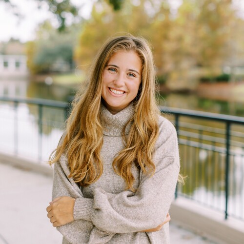 Bailey Lefever in a park near a pond
