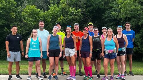 A group of men and women posing after a group run