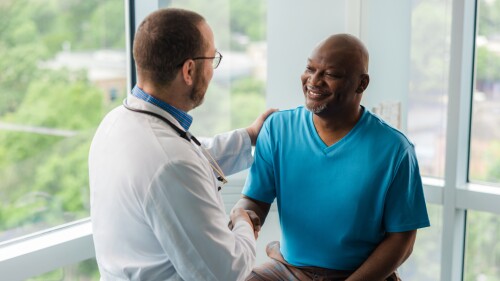 a doctor shakes the hand of a patient
