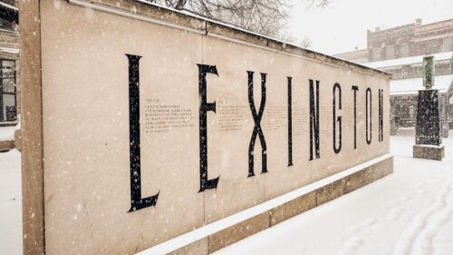 The exterior of the former courthouse with the city's sign in front on a snowy day in January 2025.