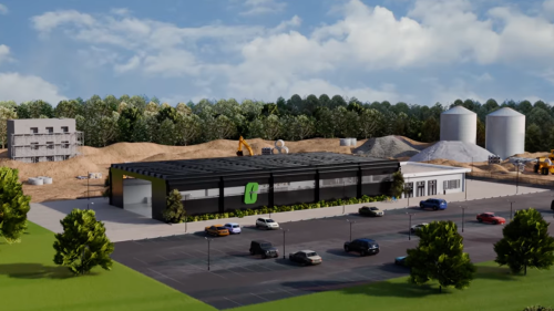 A rendering of a black warehouse with a dirt construction area behind it.