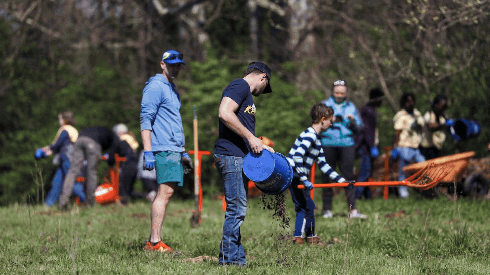 Folks planting trees at Reforest the Bluegrass