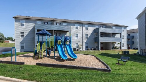 An image of apartment housing and a playground.