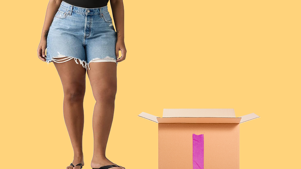 A model wearing Levi's shorts next to a cardboard box.