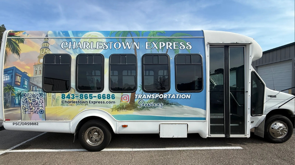 Charleston Express shuttle bus labeled “Transportation,” with colorful Charleston landmarks, palm trees, phone number, and QR code.